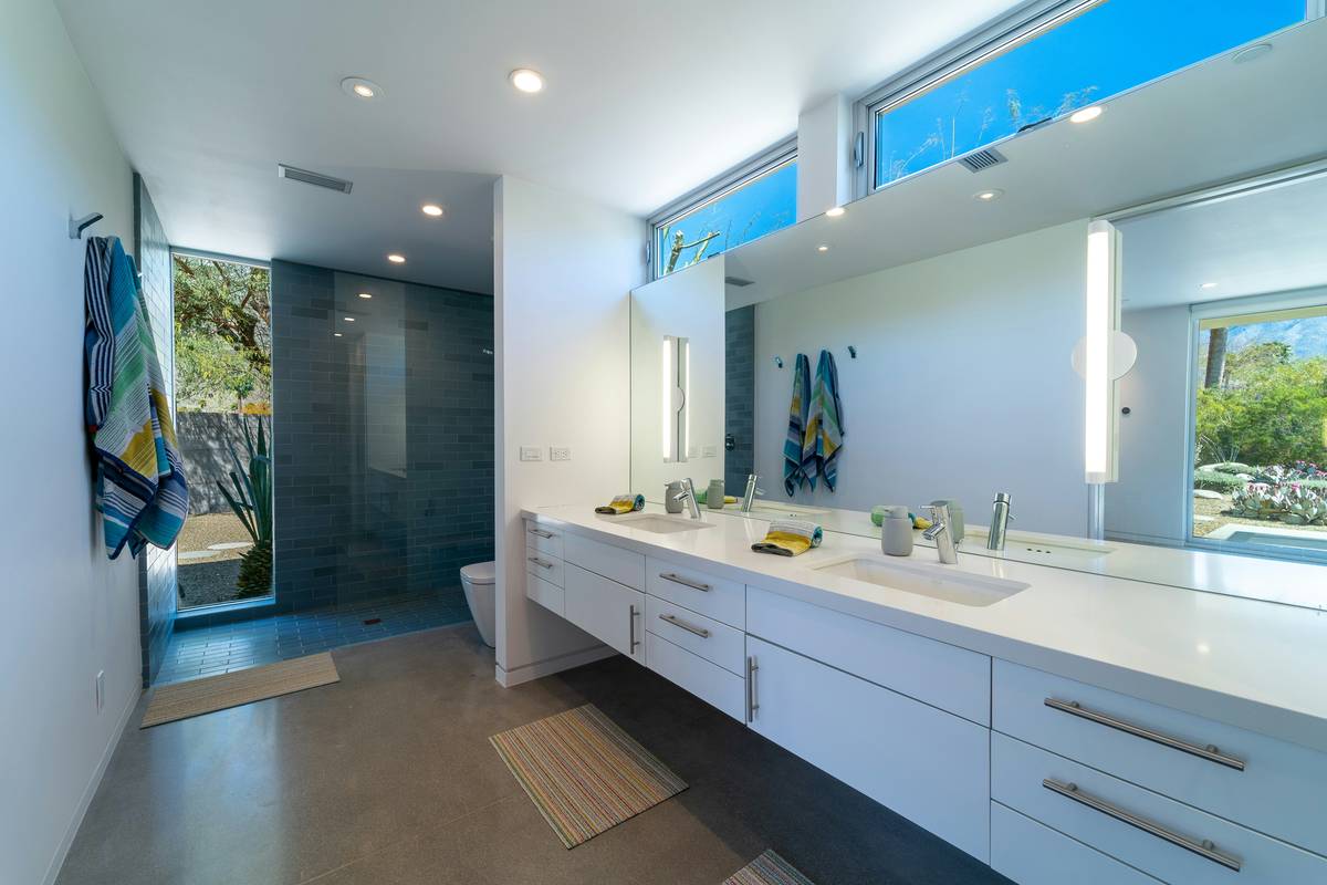 a bathroom with two sinks and a large mirror