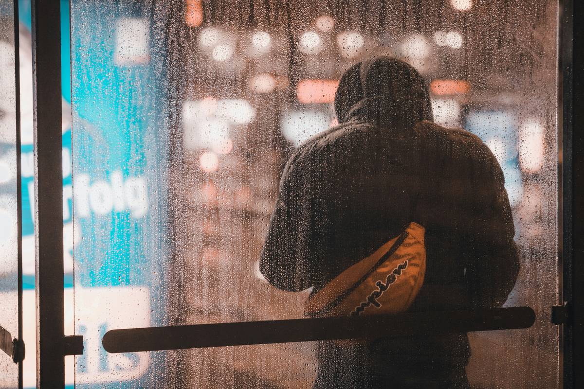 Guy waiting at the station in a moody condition.