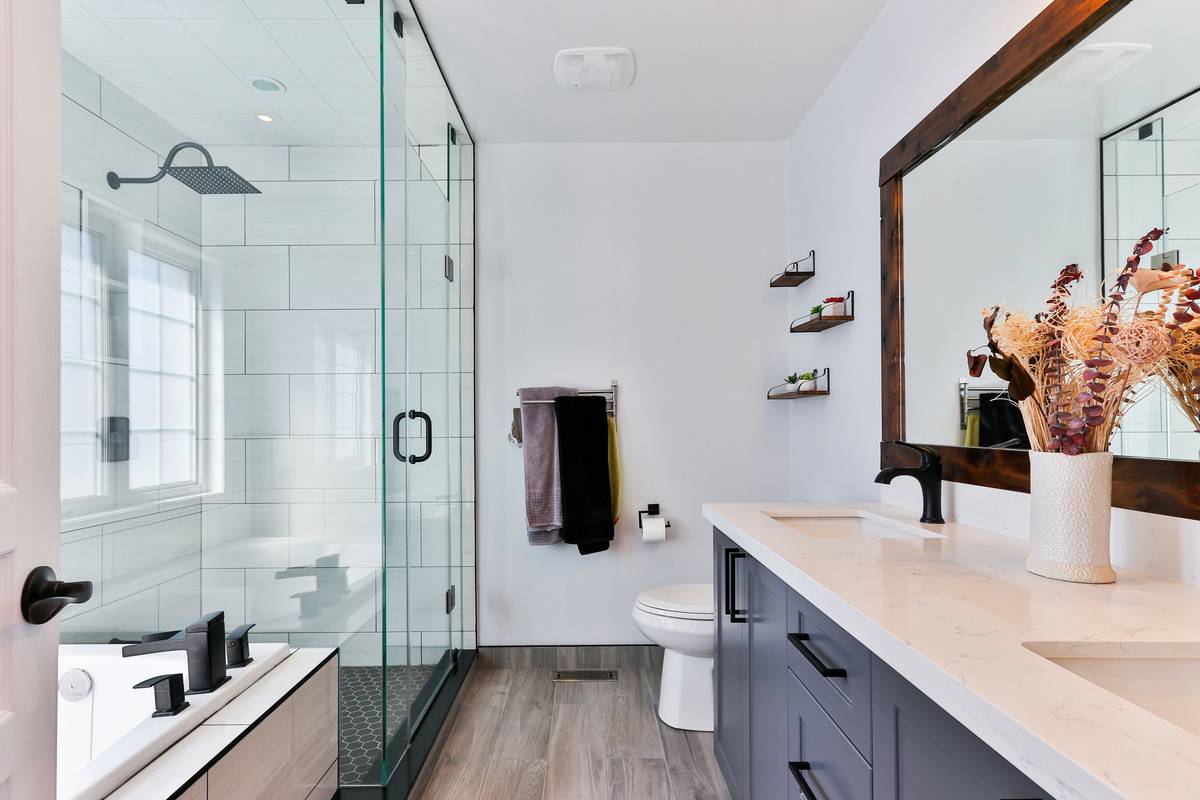 home depot dual shower heads installed in a modern bathroom with rainfall and handheld options