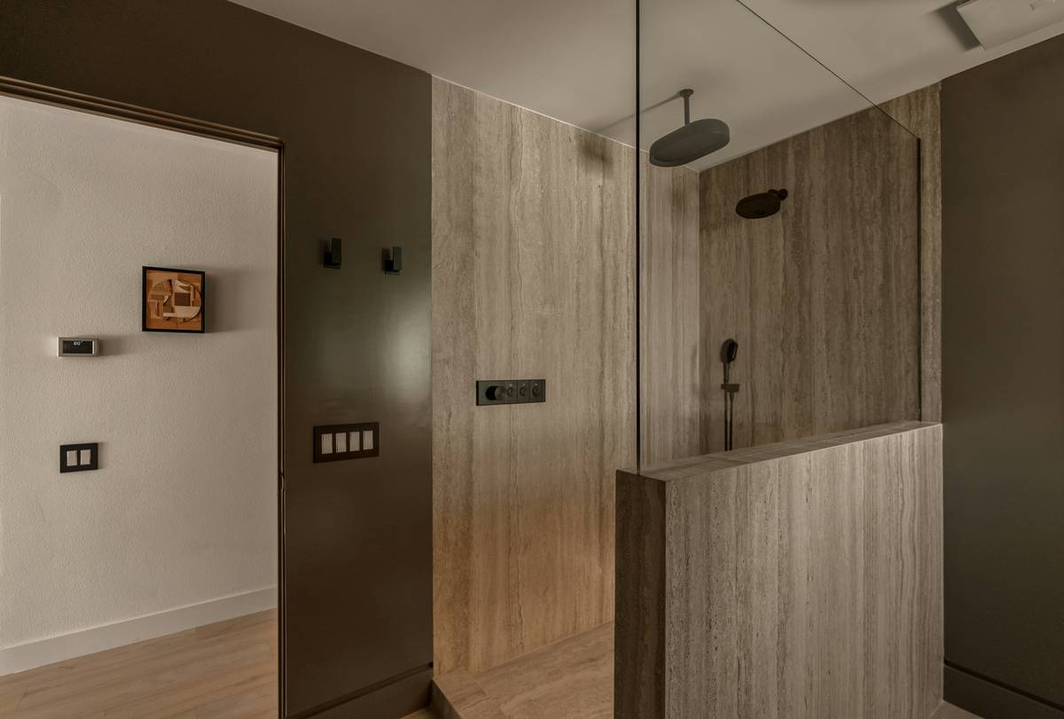 Close-up of double shower head ideas showing diverter valve and handheld nozzle setup