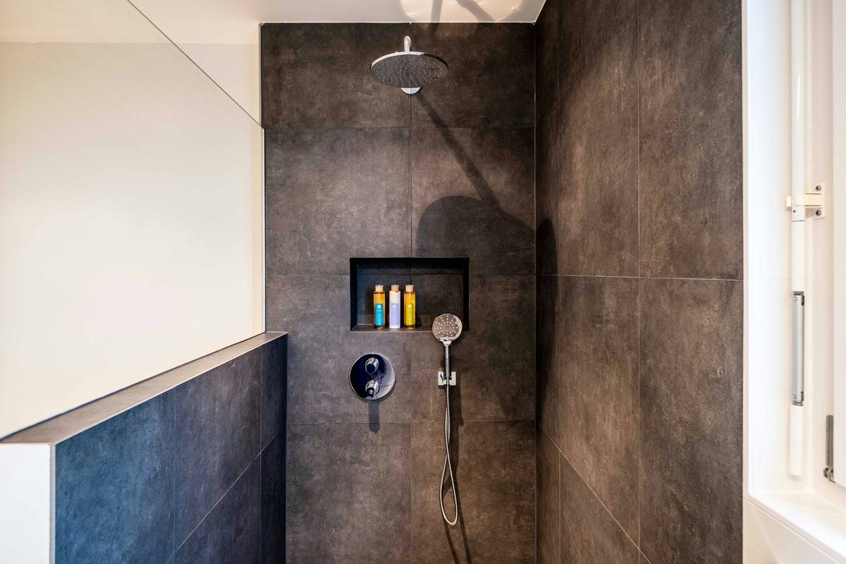Close-up of dual function shower heads showing internal valve mechanism