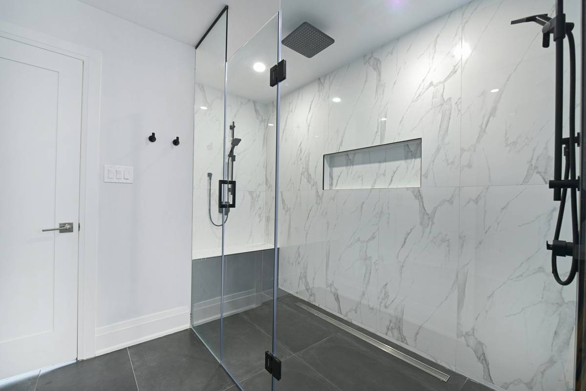 moen dual shower head and handheld installed in modern bathroom with chrome finish and rainfall ceiling mount