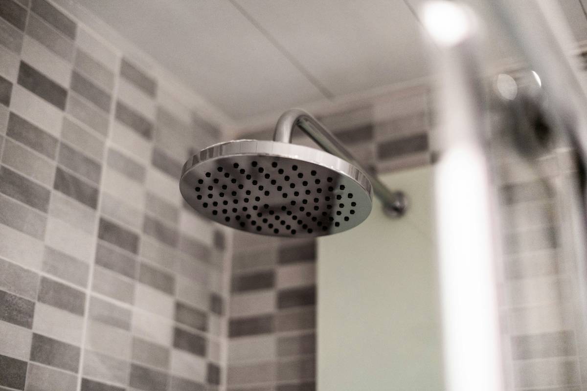 highest rated dual shower heads installed in a modern tiled bathroom with handheld and overhead rain shower